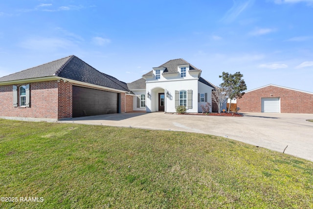 french provincial home with a front yard and a garage