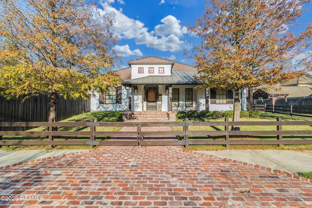 view of front of home with covered porch and a front yard