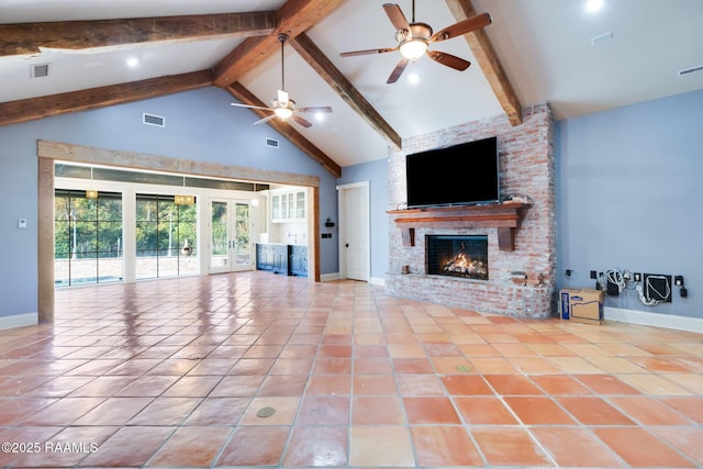 unfurnished living room featuring a brick fireplace, ceiling fan, high vaulted ceiling, beamed ceiling, and light tile patterned flooring