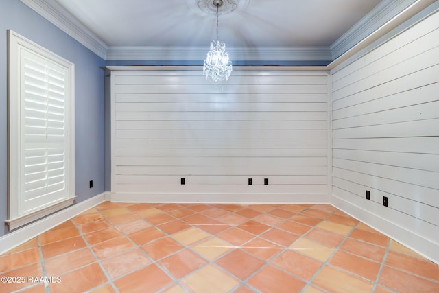 interior space featuring tile patterned flooring, a notable chandelier, wood walls, and crown molding