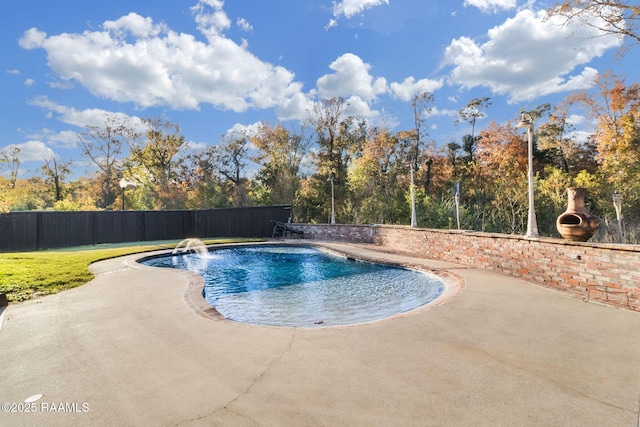 view of swimming pool featuring pool water feature and a patio area