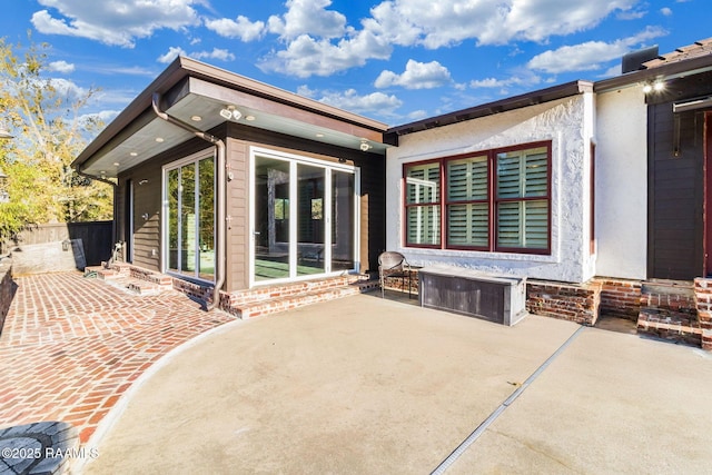 back of property with a patio