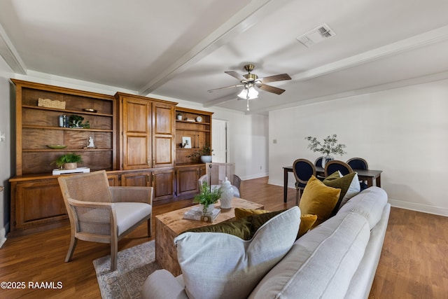 living room with hardwood / wood-style flooring, ceiling fan, and beam ceiling