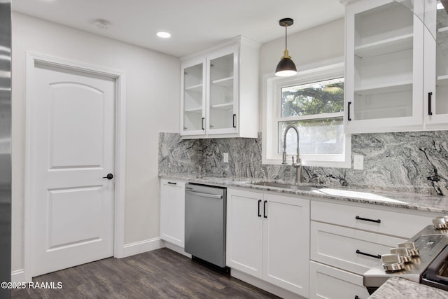 kitchen with white cabinetry, sink, hanging light fixtures, light stone counters, and stainless steel dishwasher