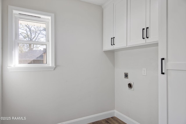 washroom featuring dark wood-type flooring, cabinets, and hookup for an electric dryer