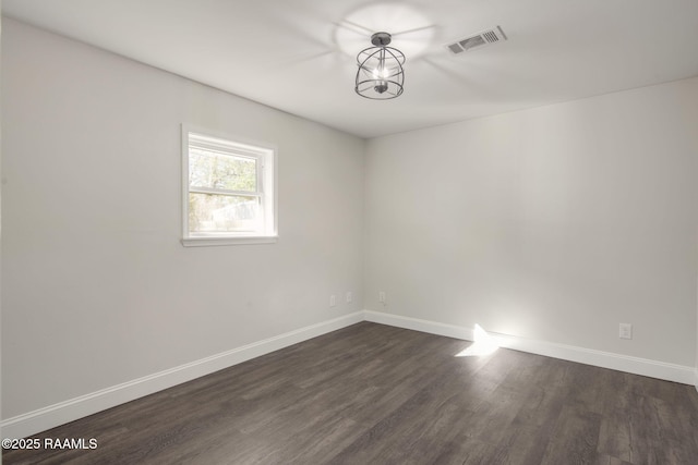 spare room featuring dark hardwood / wood-style floors