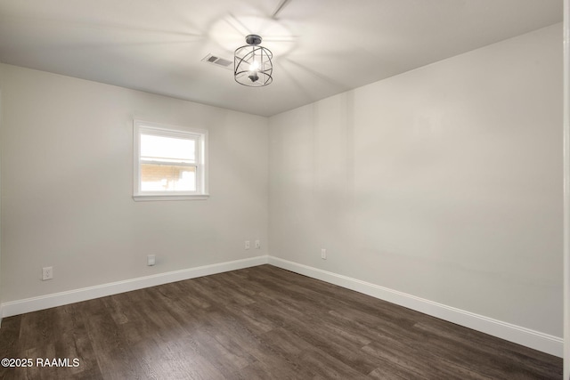 spare room with dark wood-type flooring