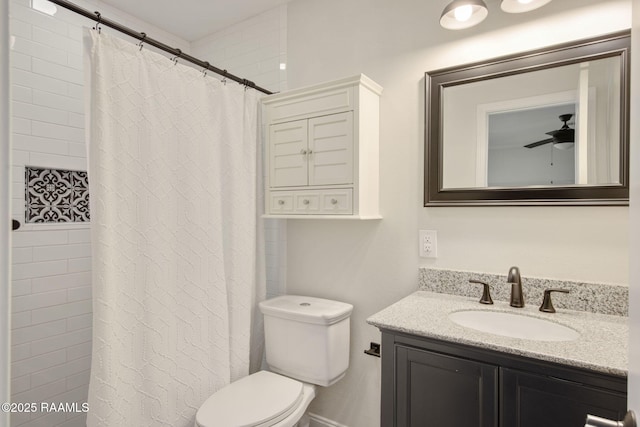 bathroom featuring a shower with shower curtain, vanity, ceiling fan, and toilet