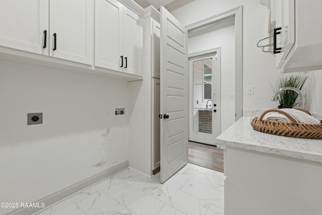 clothes washing area with hookup for an electric dryer, cabinets, and washer hookup