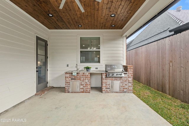 view of patio / terrace with an outdoor kitchen, area for grilling, ceiling fan, and sink