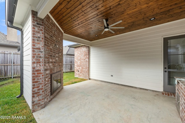 view of patio with an outdoor brick fireplace and ceiling fan