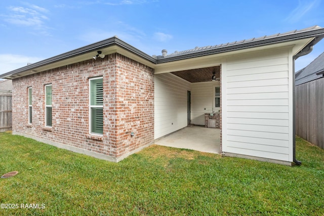 back of property with a patio area and a yard