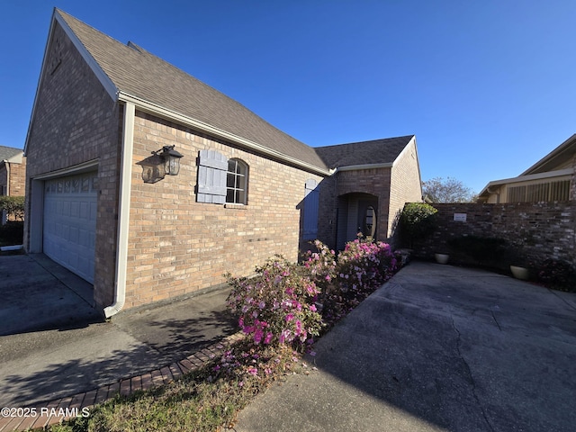 view of side of home featuring a garage