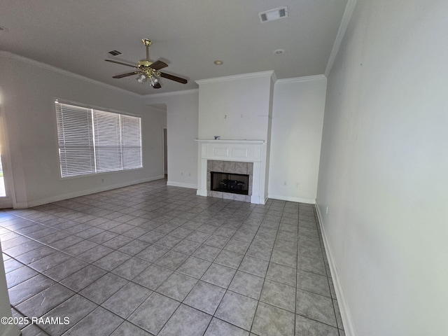 unfurnished living room featuring ceiling fan, light tile patterned flooring, crown molding, and a fireplace