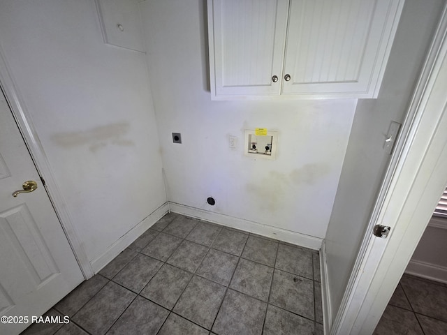 laundry room featuring cabinets, hookup for a washing machine, dark tile patterned flooring, and hookup for an electric dryer