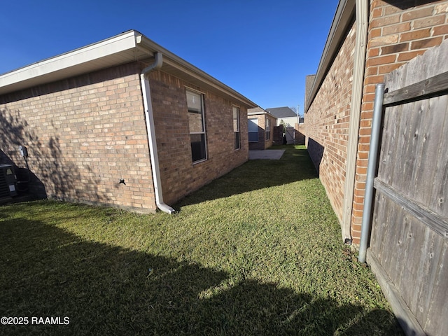 view of property exterior with a lawn