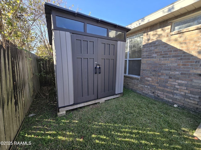 view of outdoor structure featuring a lawn