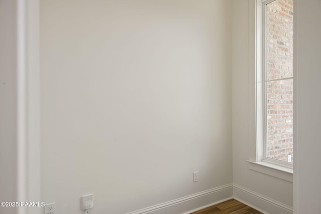 spare room featuring wood-type flooring