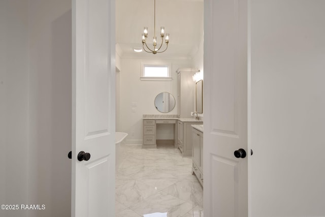 bathroom with vanity, crown molding, and a chandelier