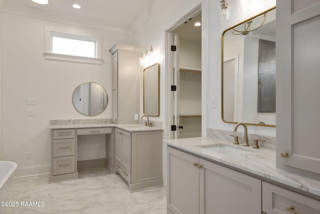 bathroom with vanity, a bath, and crown molding