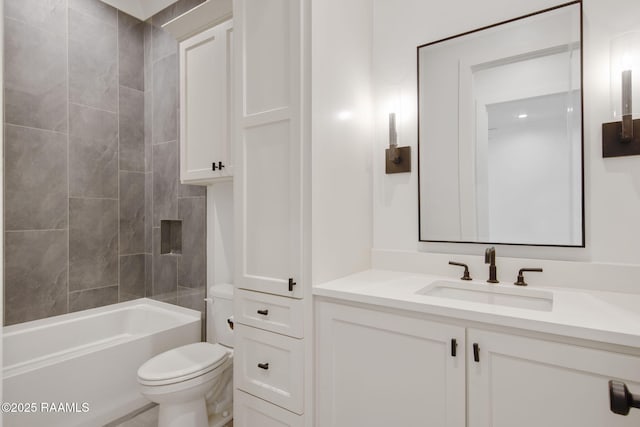 full bathroom with vanity, tiled shower / bath, and toilet