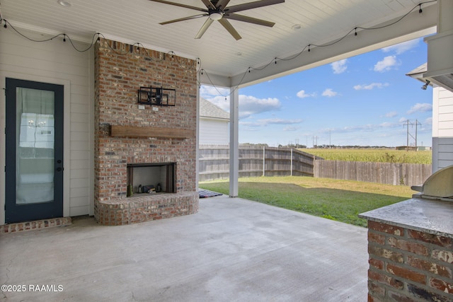 view of patio featuring an outdoor brick fireplace and ceiling fan