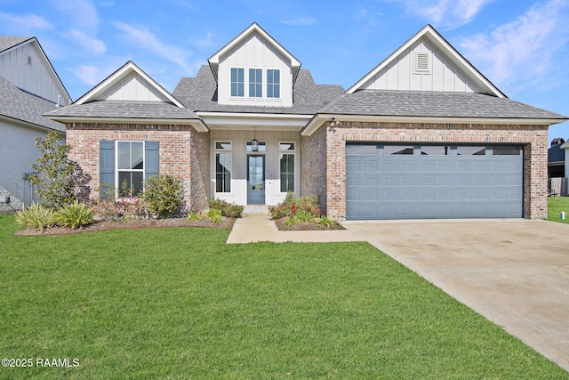 view of front of house featuring covered porch, a front yard, and a garage