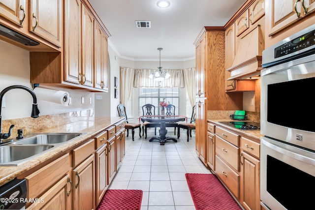 kitchen with black cooktop, double oven, crown molding, sink, and a notable chandelier