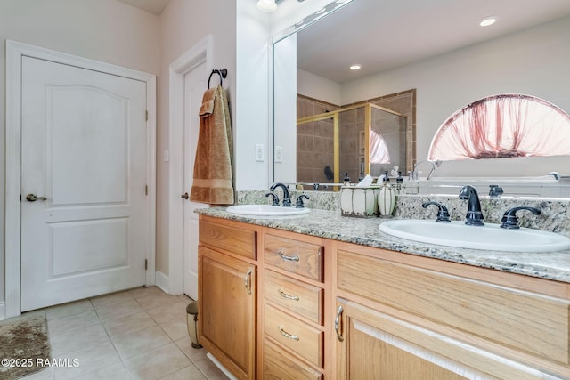 bathroom featuring tile patterned flooring, vanity, and an enclosed shower