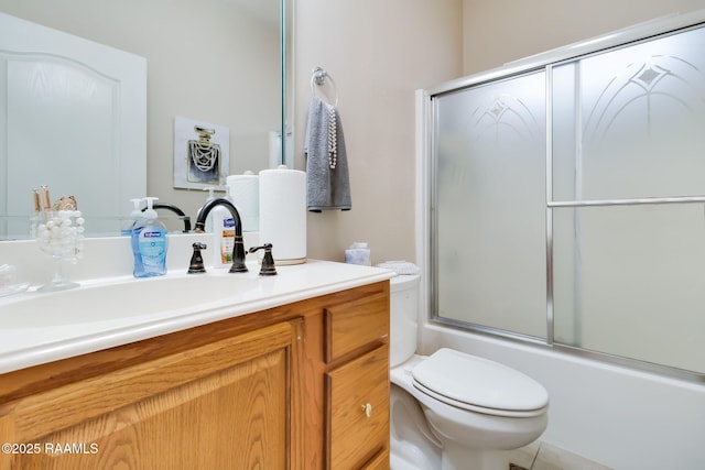 full bathroom with shower / bath combination with glass door, vanity, and toilet