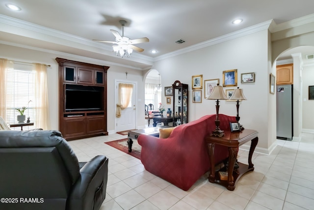 living room featuring a wealth of natural light, ceiling fan, ornamental molding, and light tile patterned flooring