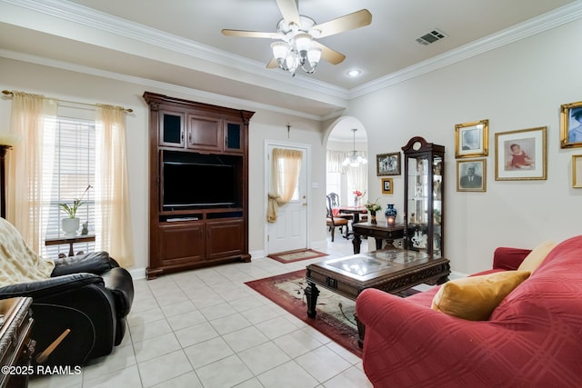 tiled living room with crown molding and ceiling fan with notable chandelier