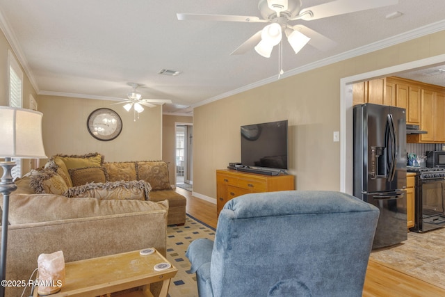 living room featuring light hardwood / wood-style floors, a wealth of natural light, and ornamental molding