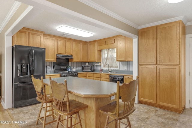 kitchen featuring black appliances, ornamental molding, a textured ceiling, a kitchen island, and a kitchen bar