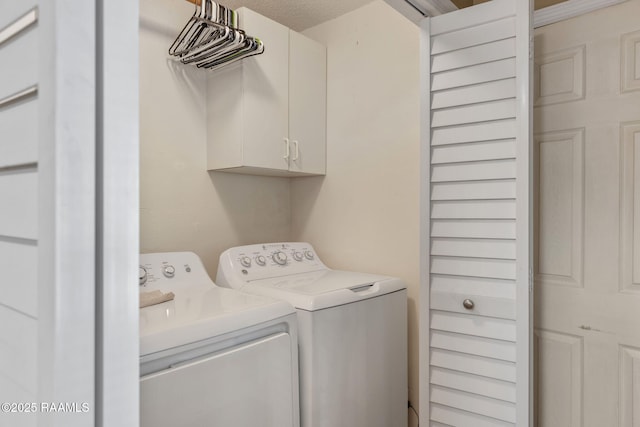 laundry room featuring cabinets and separate washer and dryer