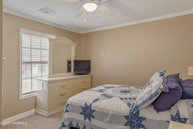 carpeted bedroom featuring ceiling fan, ornamental molding, and a textured ceiling