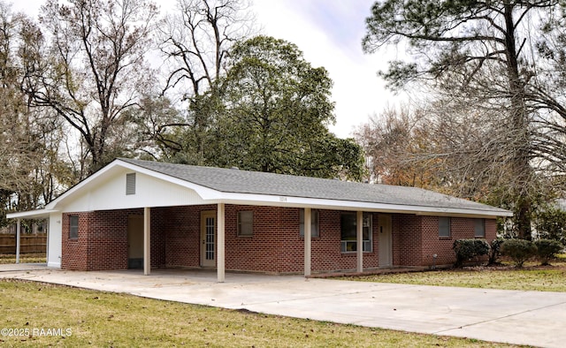 ranch-style home with a carport and a front yard