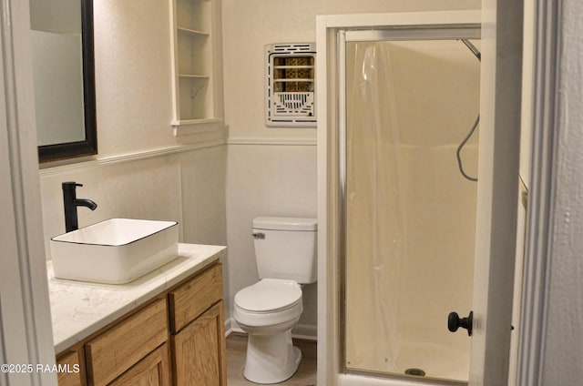 bathroom featuring vanity, wood-type flooring, toilet, and walk in shower