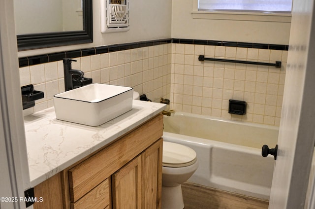 bathroom featuring vanity, toilet, and a bathing tub