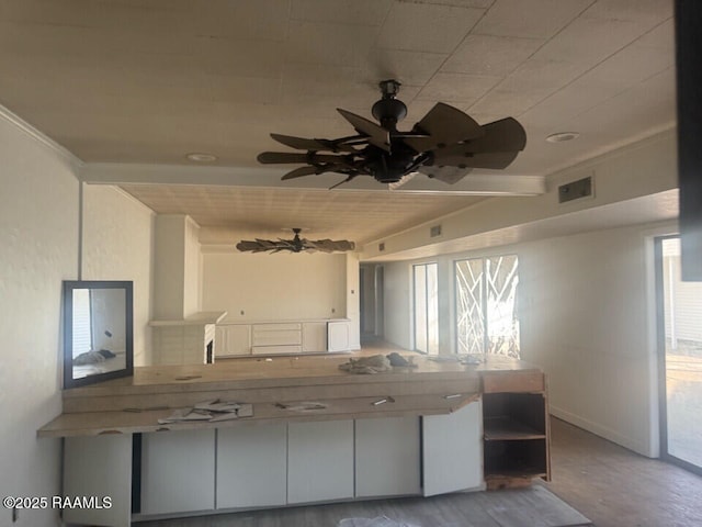 kitchen featuring beam ceiling and ceiling fan