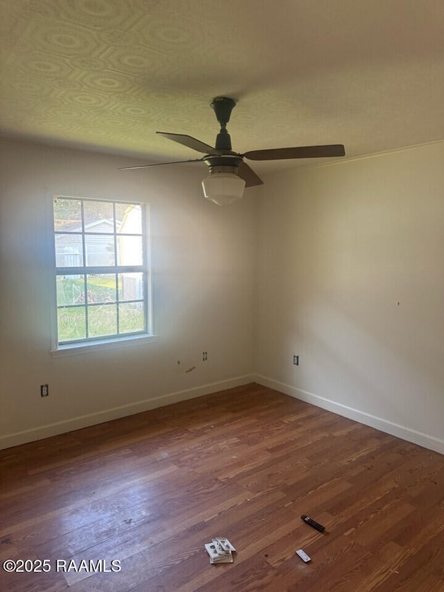 empty room with ceiling fan and dark wood-type flooring