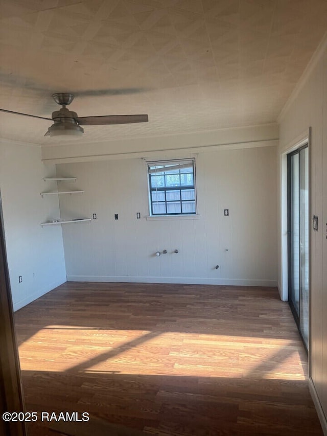 empty room featuring hardwood / wood-style floors, ceiling fan, and ornamental molding