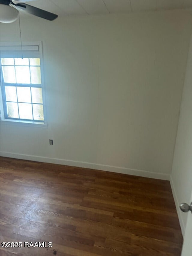 unfurnished room with dark hardwood / wood-style flooring and ceiling fan