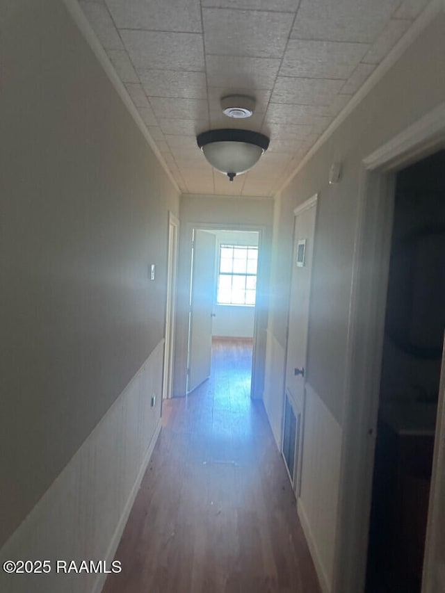 hall featuring hardwood / wood-style floors and ornamental molding