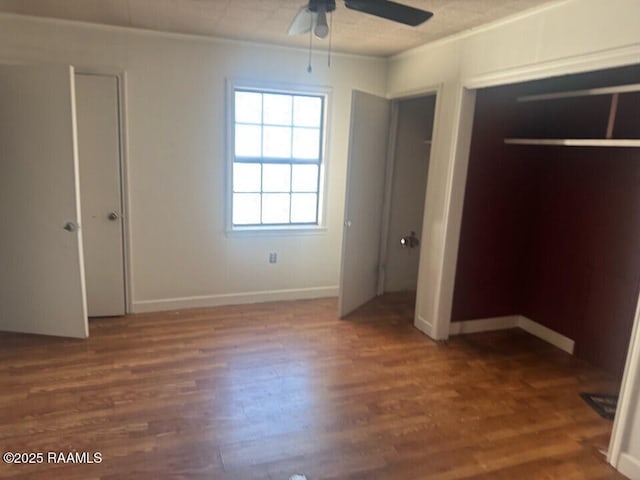 unfurnished bedroom with ceiling fan, dark hardwood / wood-style flooring, and crown molding