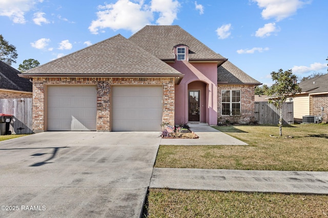 315 Begnaud Dr, Lafayette, LA 70501 - view of front facade featuring central AC, a garage, and a front lawn