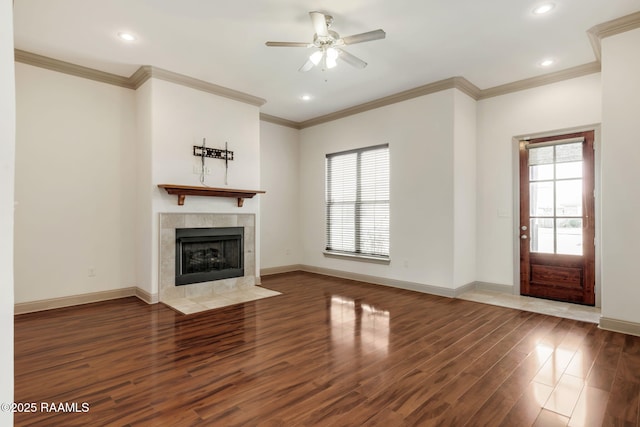 315 Begnaud Dr, Lafayette, LA 70501 - unfurnished living room featuring ceiling fan, crown molding, dark wood-type flooring, and a tiled fireplace