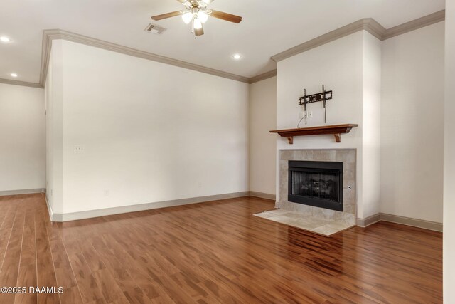 315 Begnaud Dr, Lafayette, LA 70501 - unfurnished living room featuring ceiling fan, wood-type flooring, ornamental molding, and a tiled fireplace