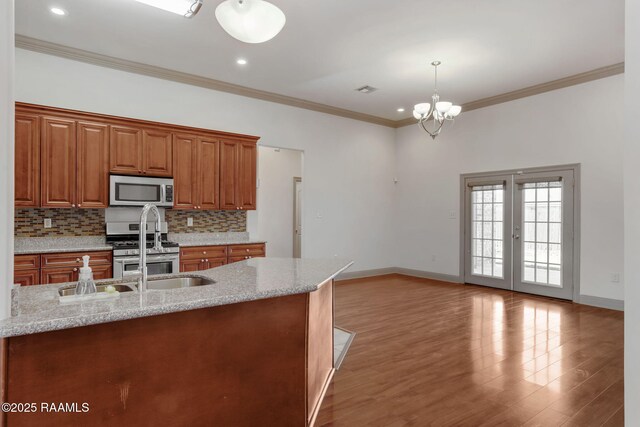 315 Begnaud Dr, Lafayette, LA 70501 - kitchen with pendant lighting, appliances with stainless steel finishes, ornamental molding, and tasteful backsplash