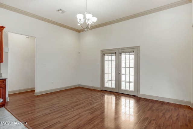 315 Begnaud Dr, Lafayette, LA 70501 - spare room featuring crown molding, dark hardwood / wood-style flooring, a chandelier, and french doors